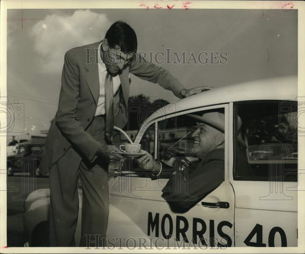 1957 J.C.B. Richmond serves tea to Morris Frank, columnist.-Historic Images