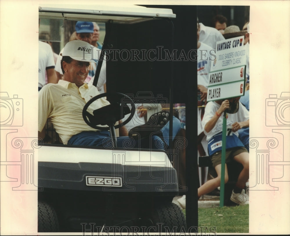 1991 Golfer George Archer relaxes in a golf cart waiting his turn - Historic Images