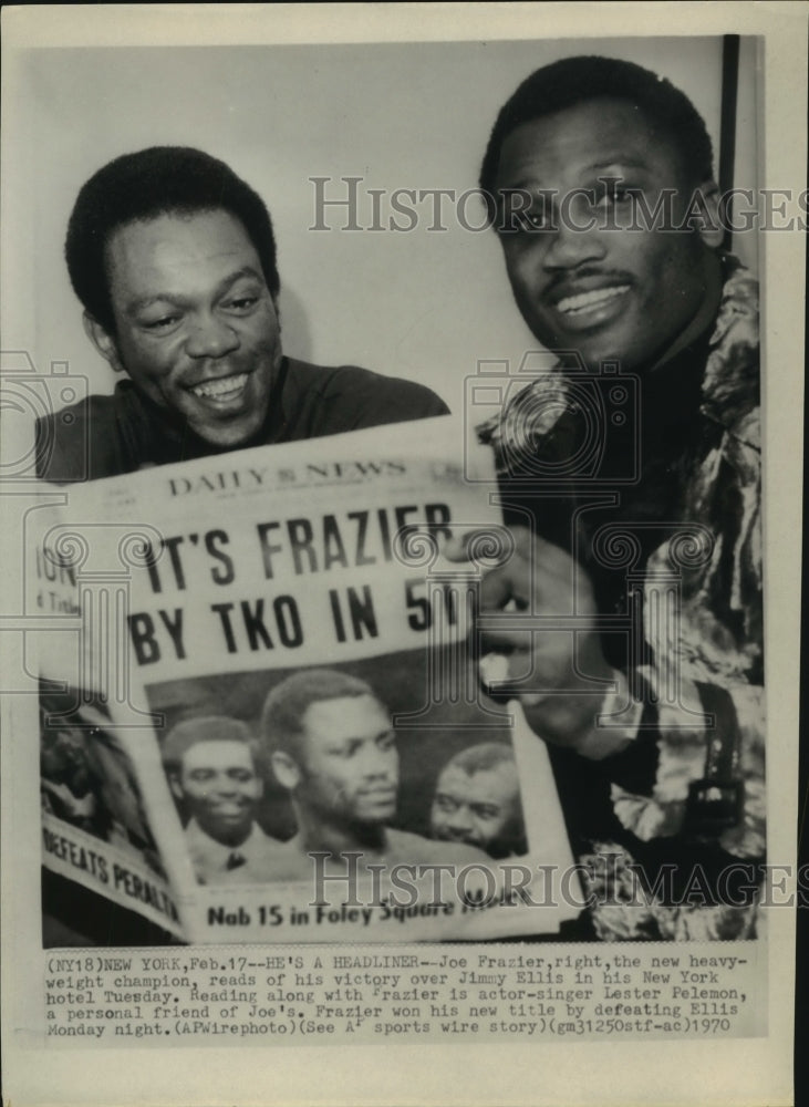 1970 Press Photo Joe Frazier, new heavyweight boxing champion reads TKO headline- Historic Images