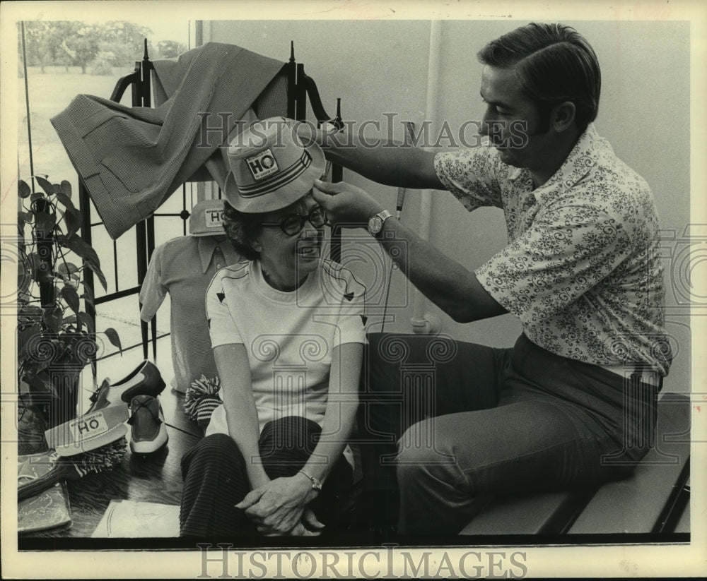 1972 Press Photo Golfer fits a fan with a new hat. - hcs07152- Historic Images