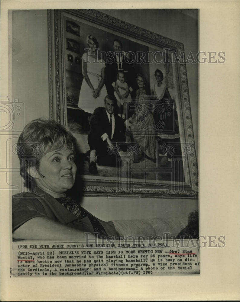 1963 Mrs. Stan Musial sits in front of a Musial family photo. - Historic Images