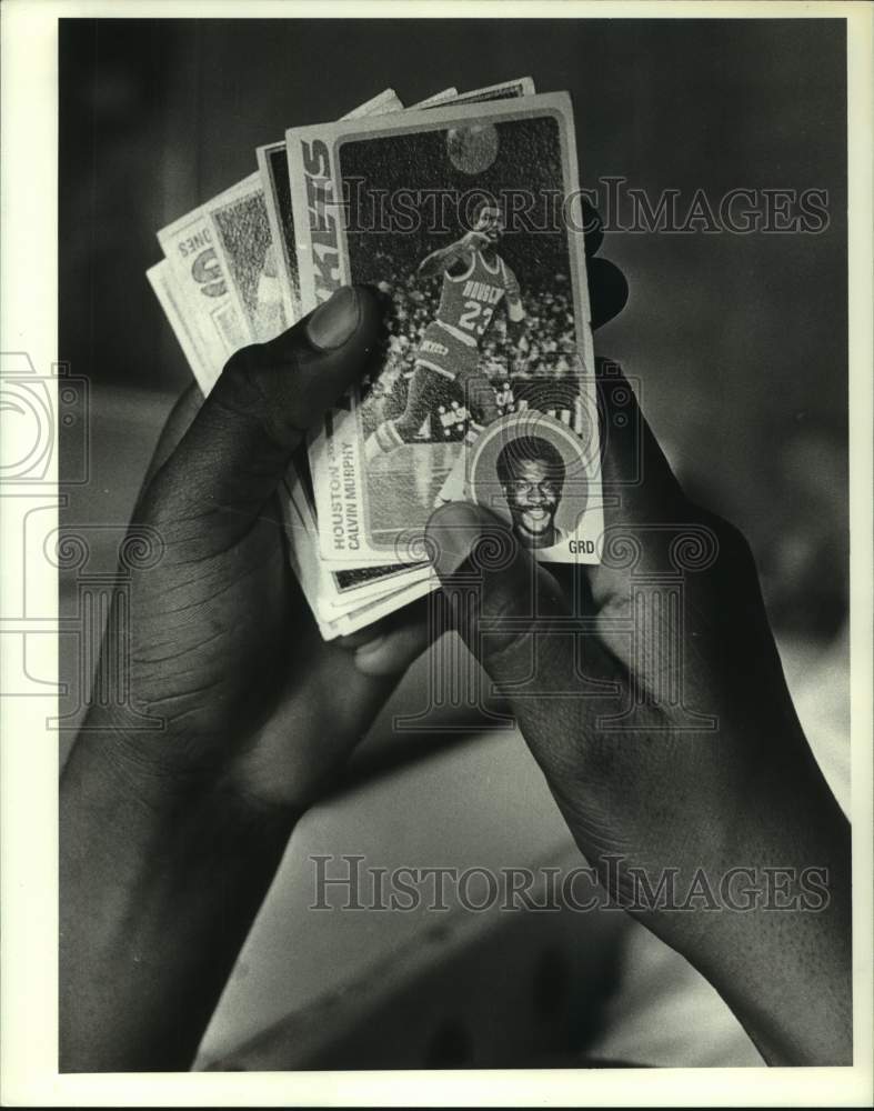 1983 Press Photo Rockets&#39; ball boy Duane Broussard checks out basketball cards.- Historic Images