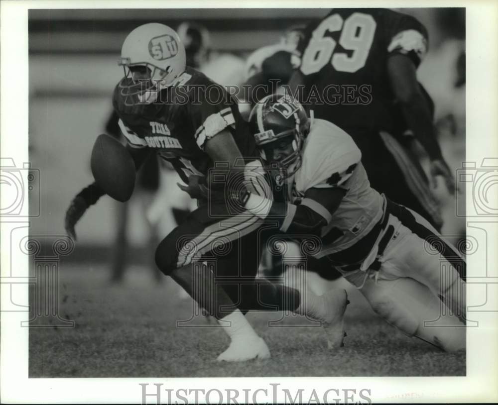 1991 TSU's Stacy Moore fumbles; Jackson States' Carl Tart makes hit. - Historic Images