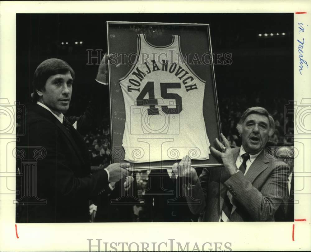 1982 Rockets' coach Rudy Tomjanovich presented with retired jersey. - Historic Images