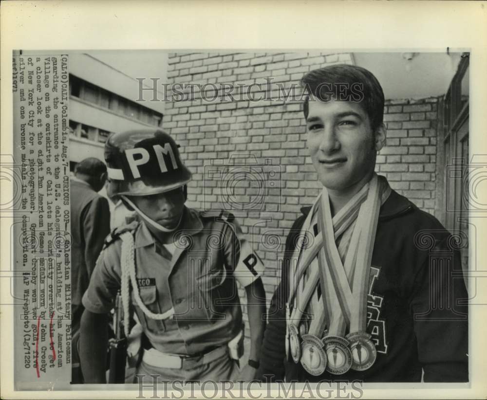 1971 Colombian military police guard admires John Crosby's medals - Historic Images