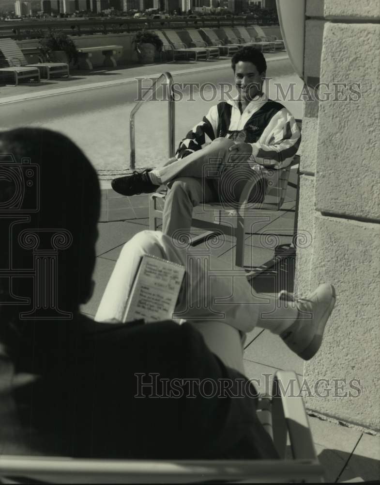 1989 Olympic diver Greg Louganis being interviewed by the pool - Historic Images
