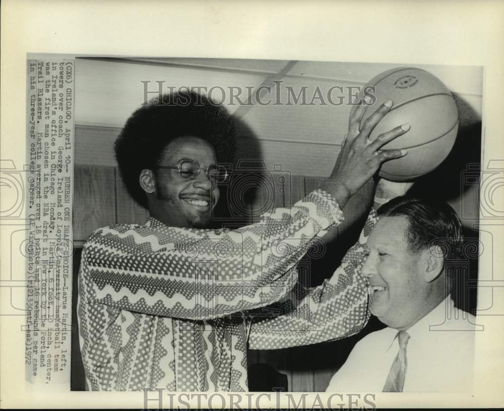 1972 Larue Martin towers over basketball coach George Ireland - Historic Images