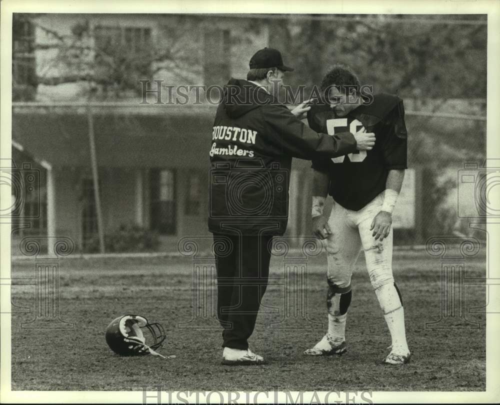 1986 Coach Jack Pardee helps linebacker Kevin McClain after practice - Historic Images