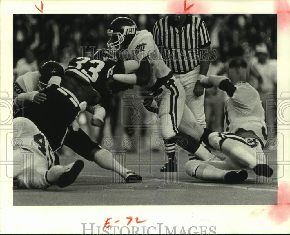 1983 Press Photo Rice&#39;s Kevin Trigg is wrapped up by TCU tackler. - hcs15541- Historic Images