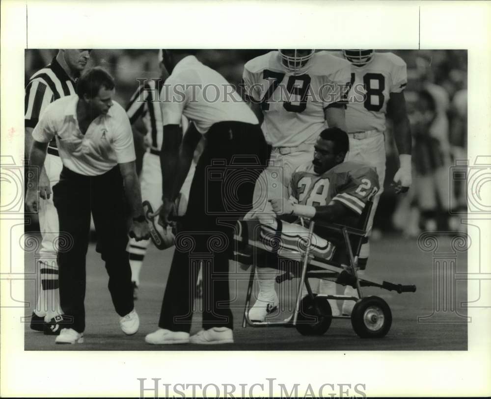 1987 Oilers&#39; Allen Lyday is carted from field after knee injury. - Historic Images