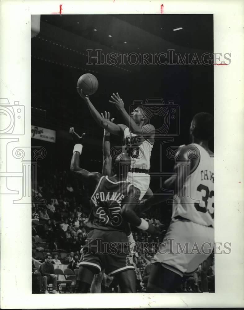 1990 Rockets' Kenny Smith soars above Suns' Xavier McDaniel. - Historic Images