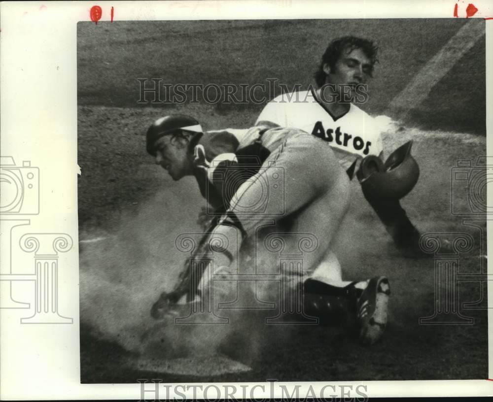 Astros&#39; Terry Puhl tagged out by Braves Biff Pocoroba at the plate. - Historic Images