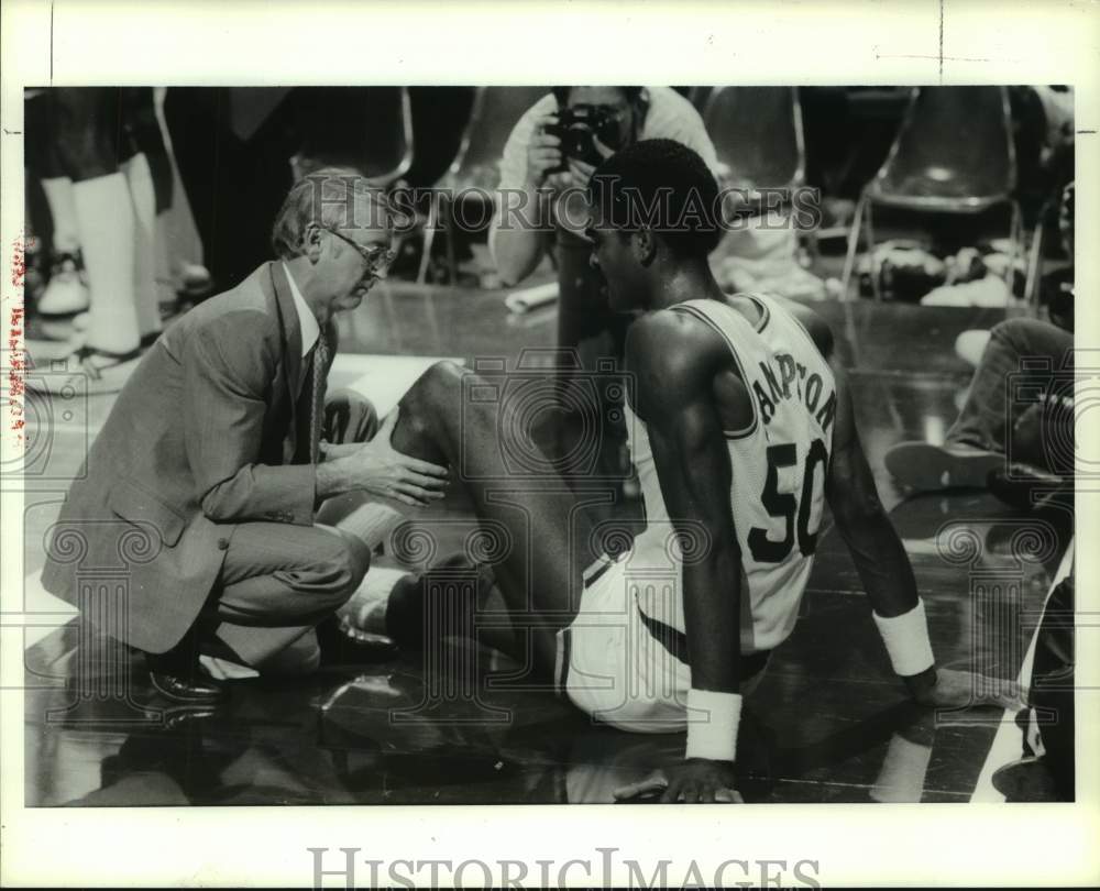 1987 Rockets trainer Dick Vandervoot working on Ralph Sampson's leg - Historic Images