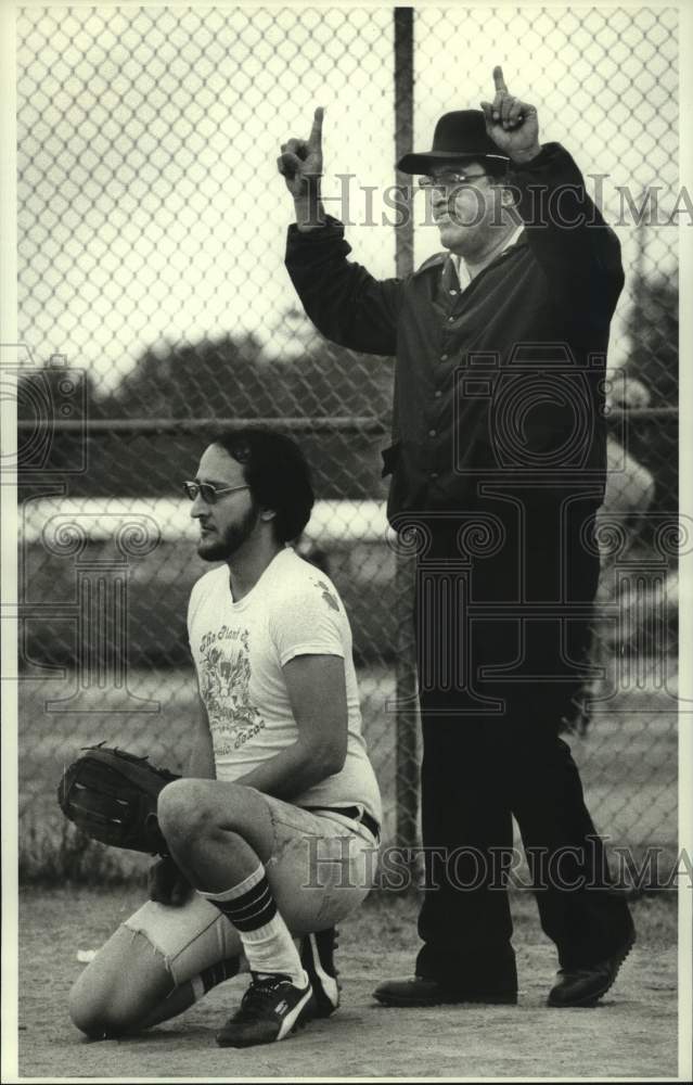 1980 Umpire shows the count as 1 and 1 as catcher readies for pitch. - Historic Images