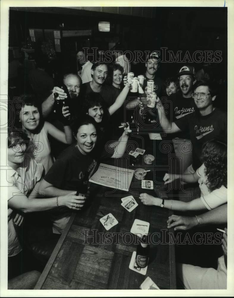 1988 Members of the Injuns enjoy fun after their softball game. - Historic Images