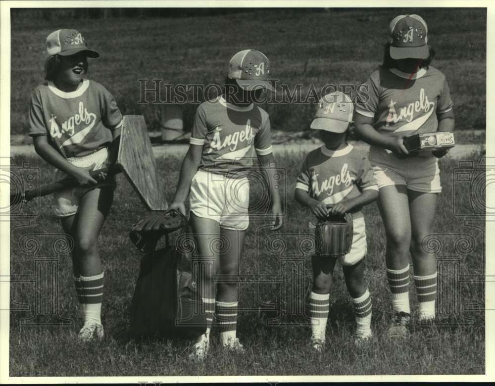 1980 Members of Angels softball team coming to game. - Historic Images