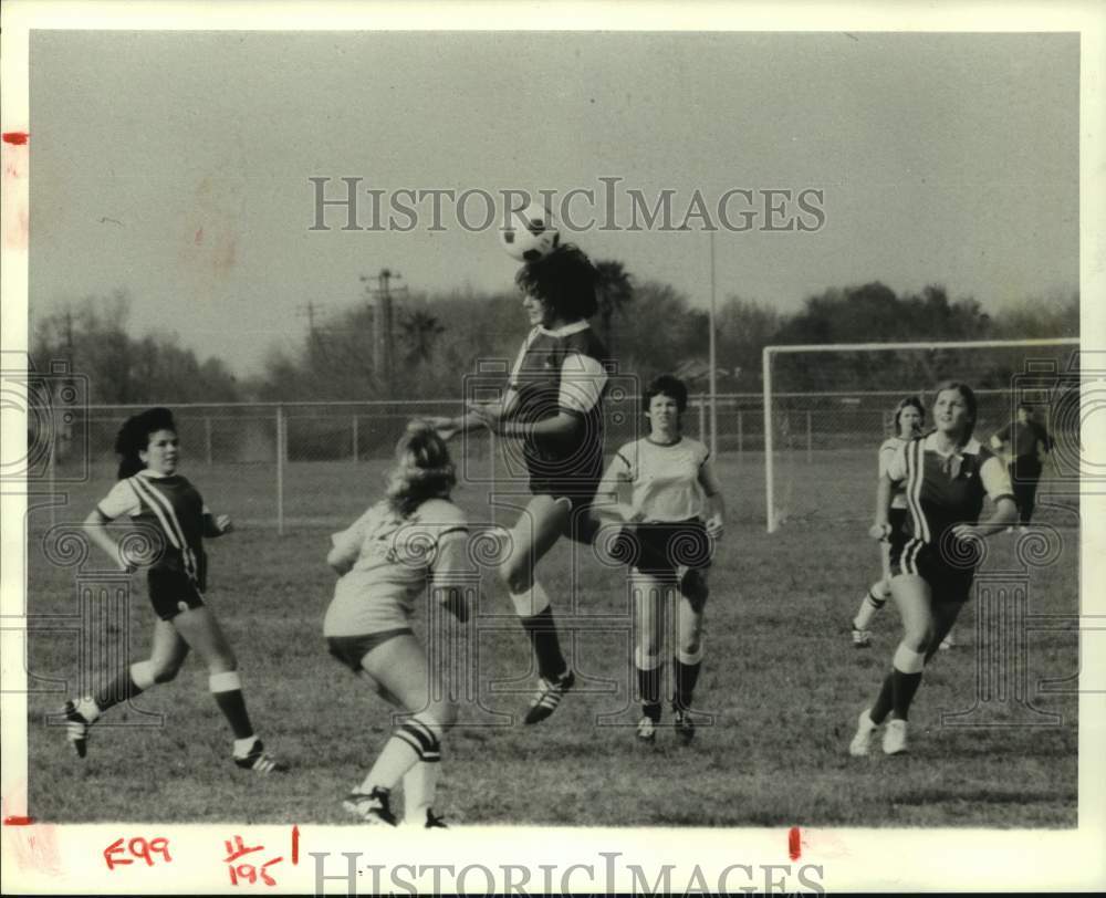 Young lady uses her head in ladies soccer match.-Historic Images