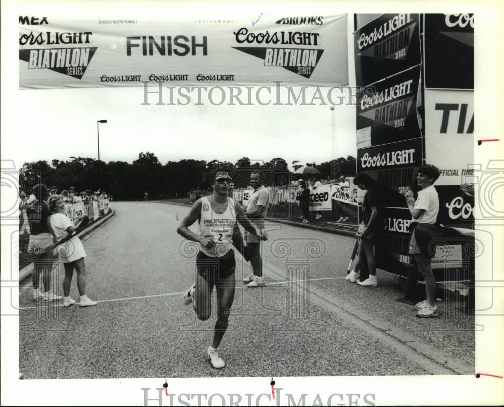 1990 Press Photo Brent Steiner crosses line to win Coors Light Baithlon.- Historic Images