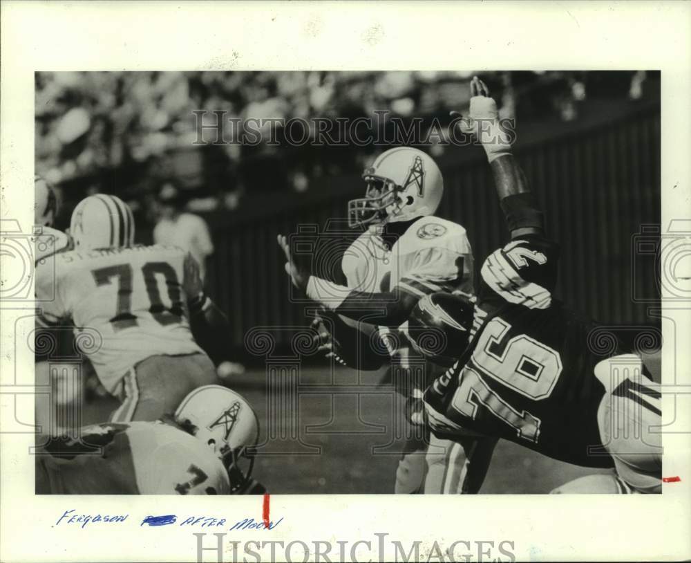 1984 Press Photo Houston Oilers football player Warren Moon tries to avoid sack - Historic Images