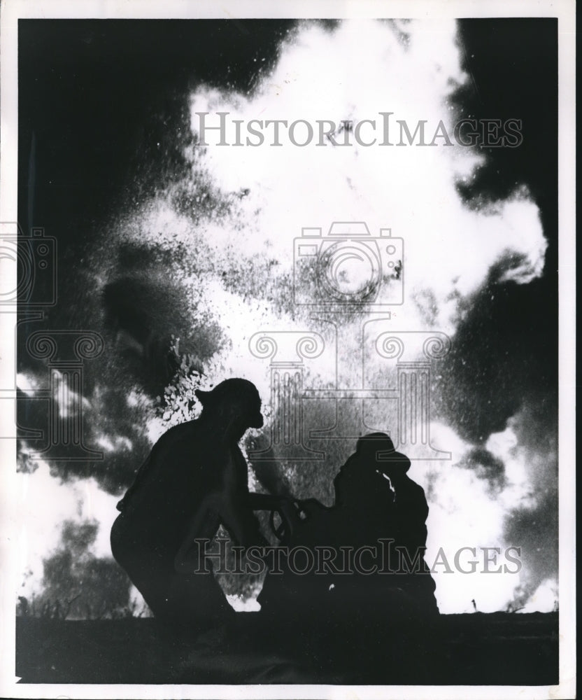 1962 Press Photo Firemen battle explosion-fire at Sinclair Storage Farm- Historic Images