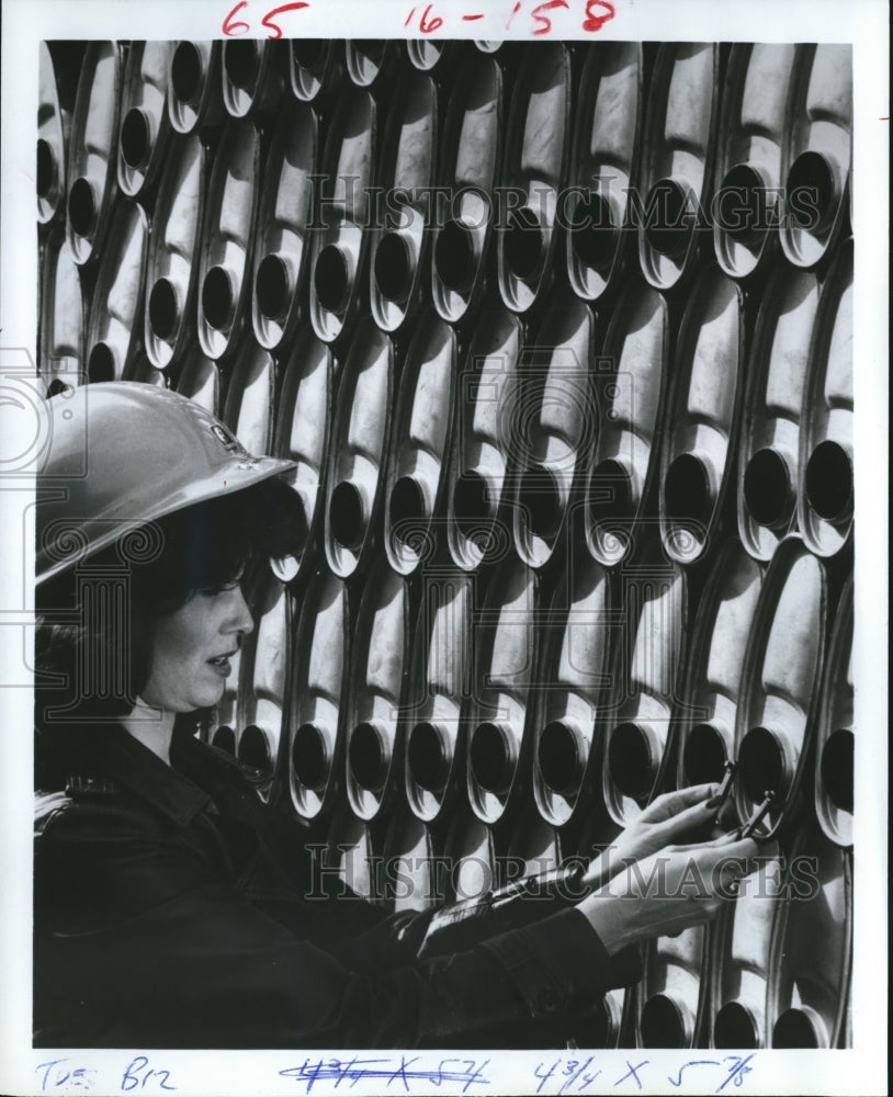 1981 Judy Parnell checks parts Tenneco Automotive&#39;s Walker plant, TX - Historic Images