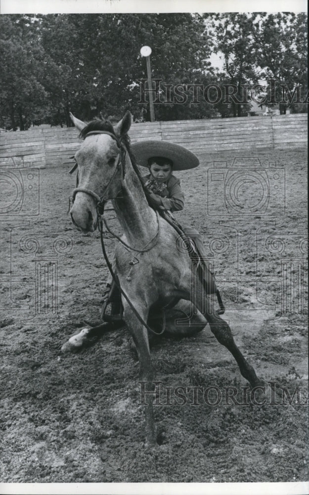 1973 Child sits on sitting horse, Charros - Historic Images