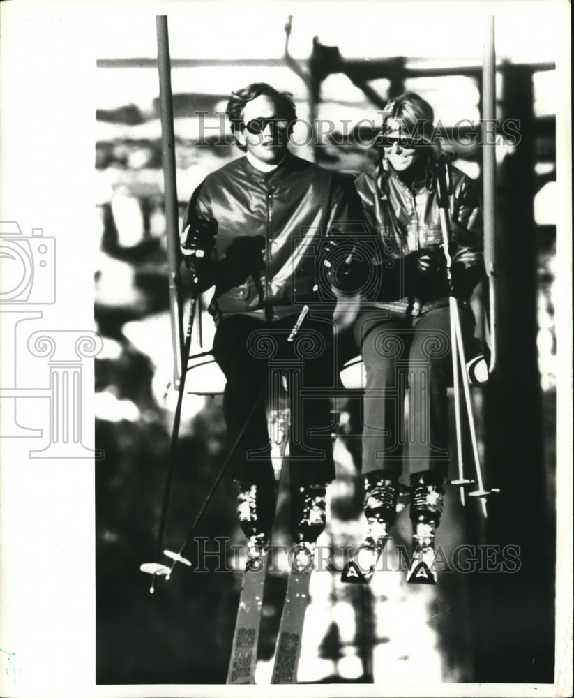 1971 Couple in Chairlift heads up the ski slope - Historic Images