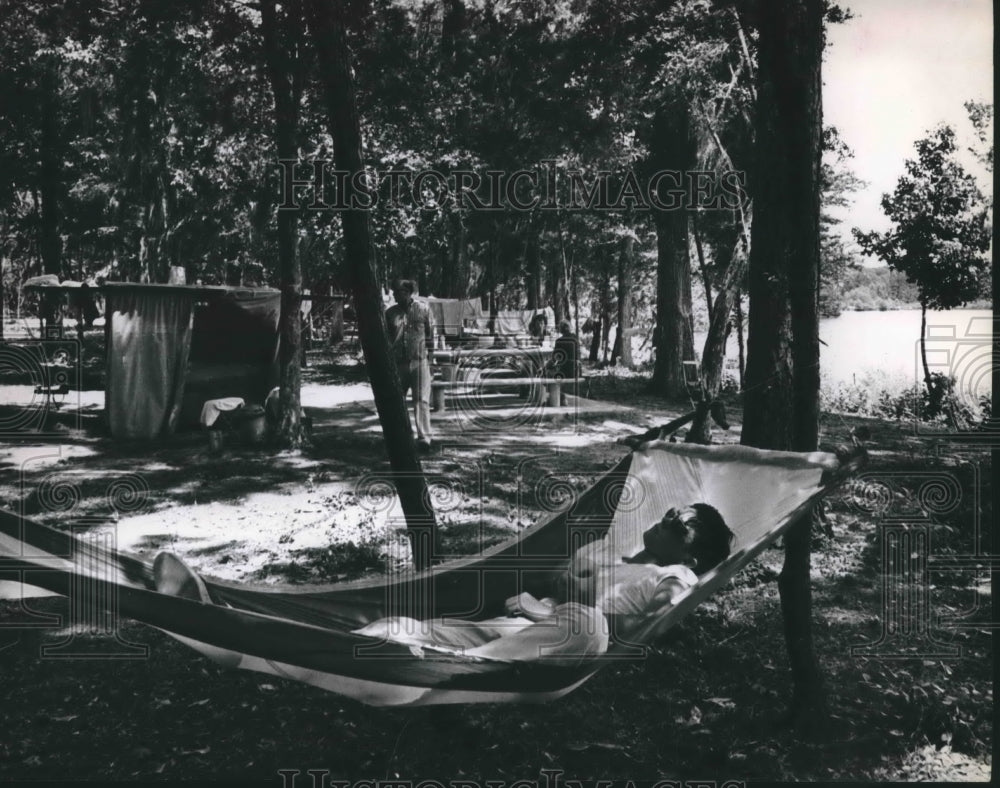 1965 Camper relaxing in the shade at Dam B. State Park - Historic Images