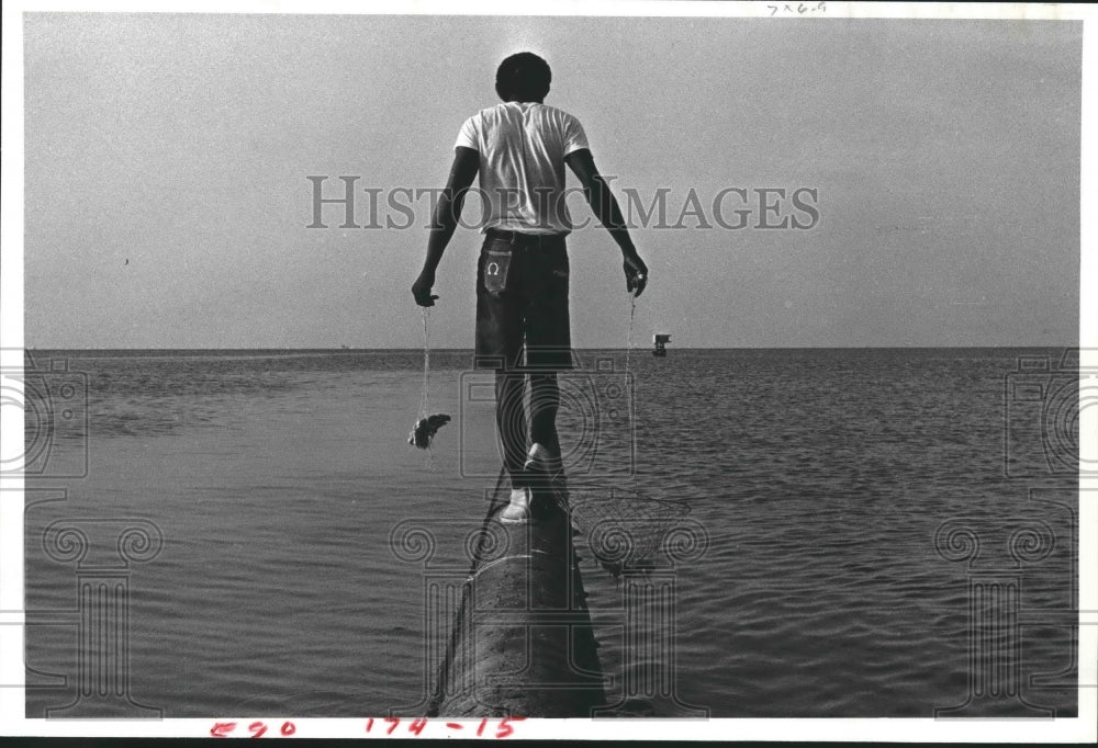 1982 Press Photo A Crabber With Chicken Bait and Net Maneuvers Texas Break-wall. - Historic Images