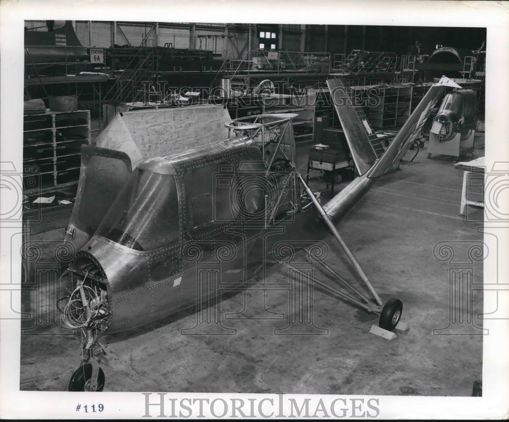 1960 Partial helicopter inside a warehouse - Historic Images