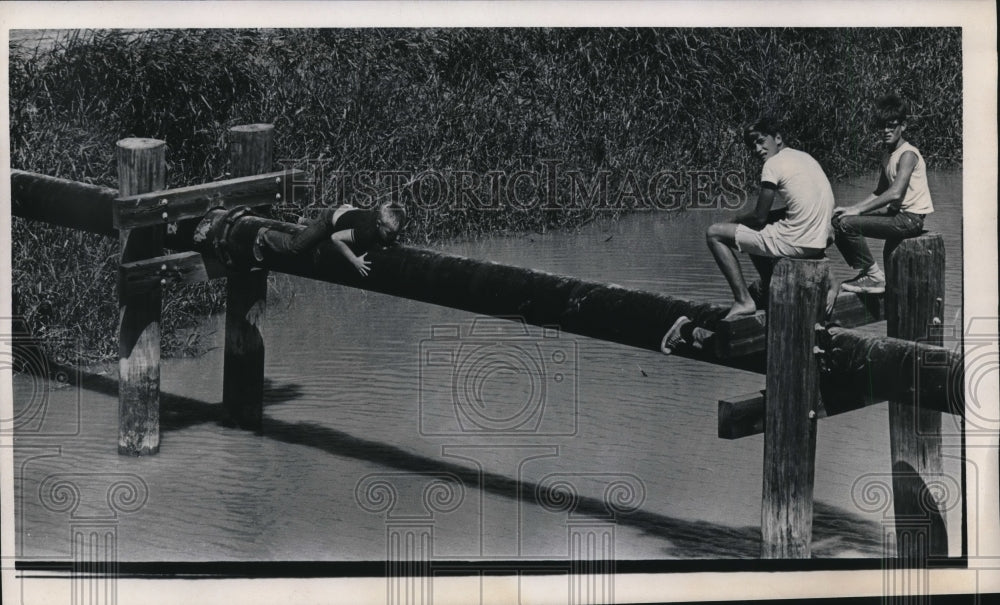 1961 Kids Sitting on Dock Pillars In Harlingen, Texas. - Historic Images