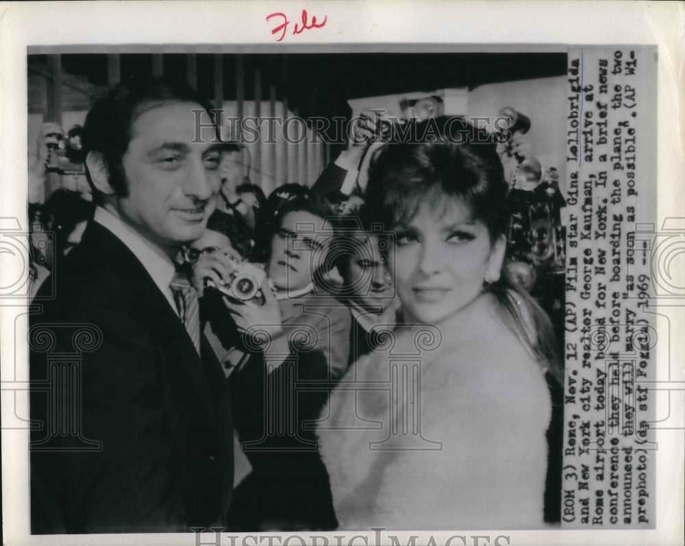 1969 Gina Lollobrigida and George Kaufman before boarding plane - Historic Images
