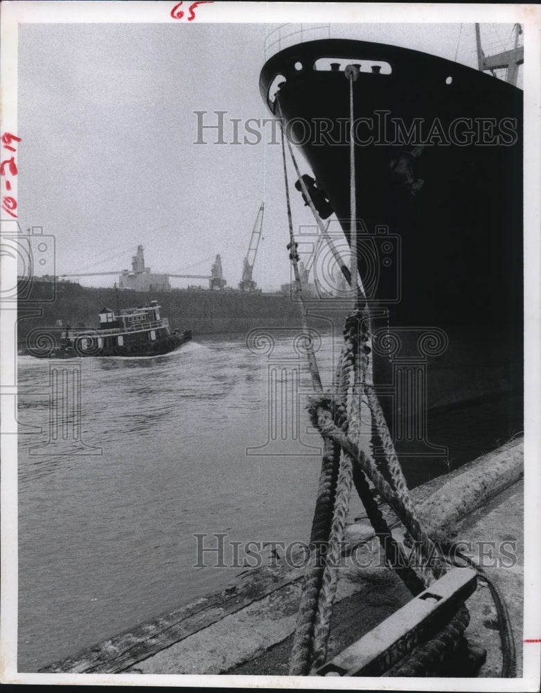 1978 tugboat in Houston ship channel between freighters - Historic Images