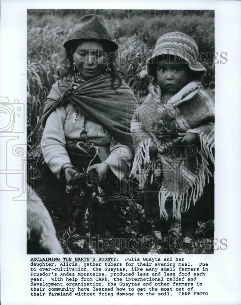 1990 Press Photo Julia Guayta and her daughter, Alicia gather tubers in Ecuador - Historic Images