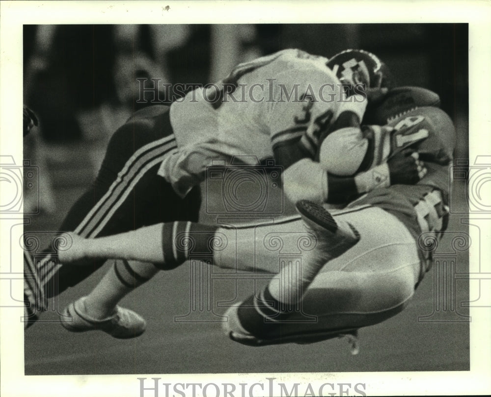 1985 Houston Oilers Steve Bryant Cradling Football & Lloyd Burruss. - Historic Images
