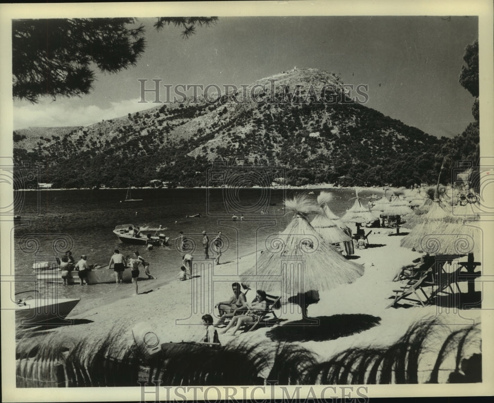 1965 Vacationers relax at Formentor beach on the island of Majorca - Historic Images