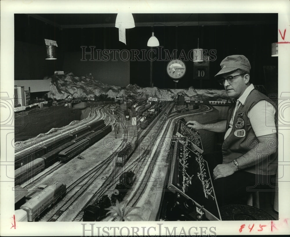 1977 Kenneth E. Caulking at controls of his Model Train Railroad - Historic Images