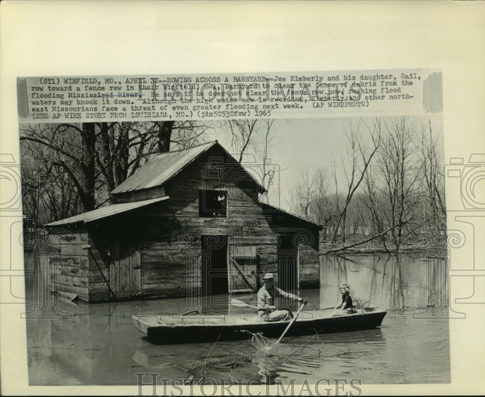 1965 Kimberly and daughter Gail in flooded yard, Mississippi River - Historic Images
