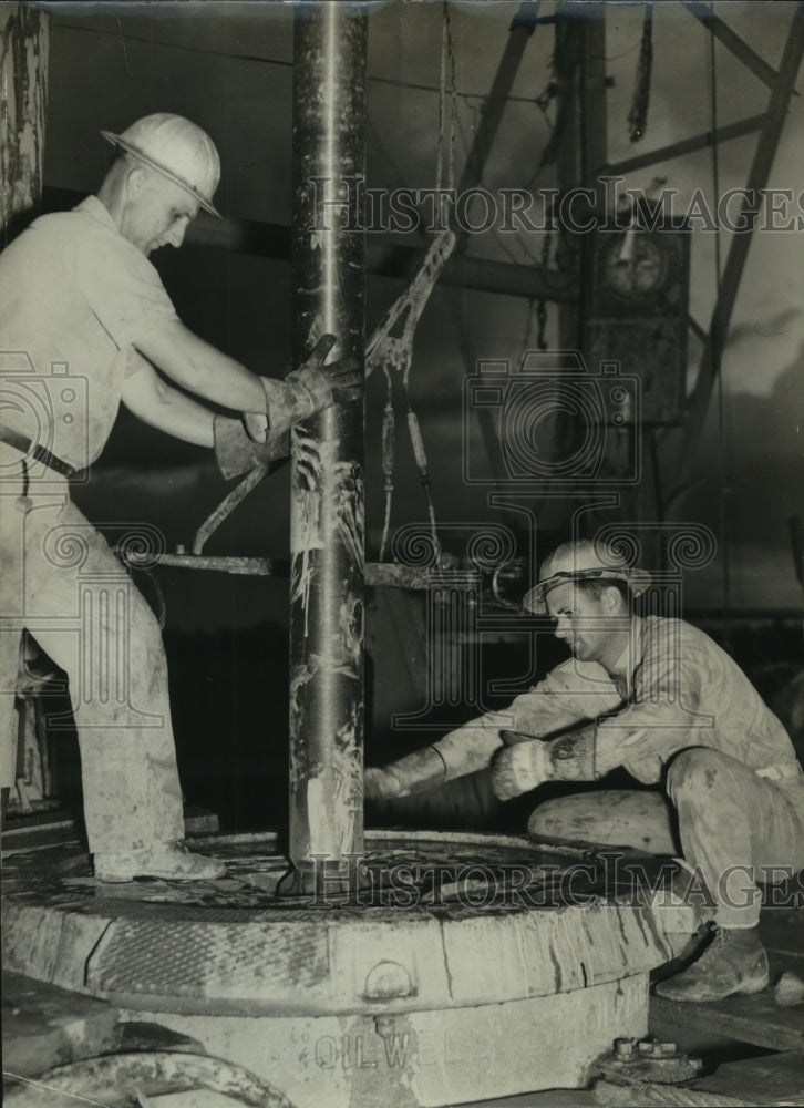 1940 Workers Steadying Drill Stem For United Gas Pipe Line Corp. - Historic Images