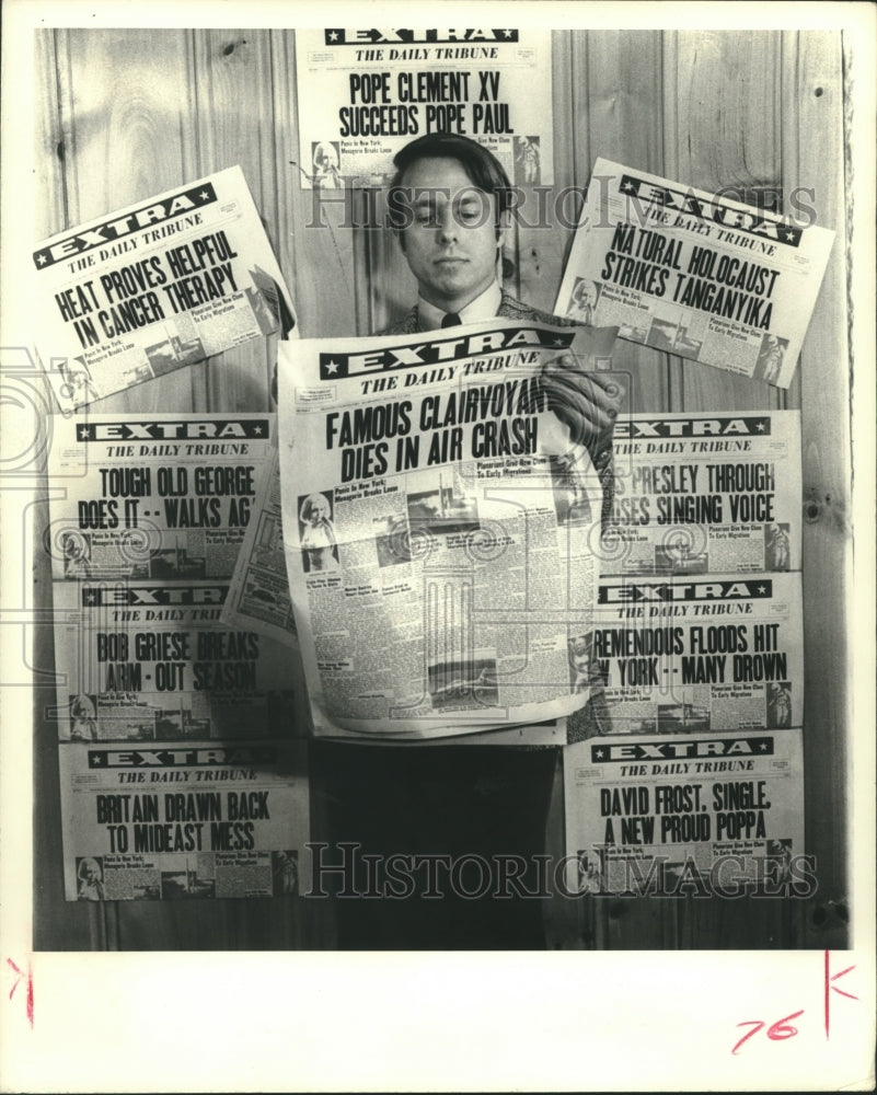 1972 Robert Nelson glances at Jeane Dixon's (clairvoyant) headlines. - Historic Images