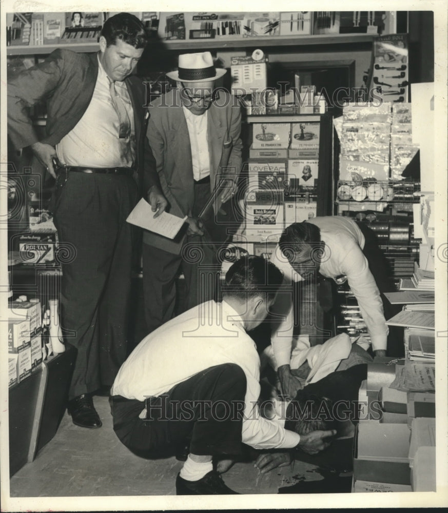 1959 Four people surround injured man at Powers Drugs - Historic Images