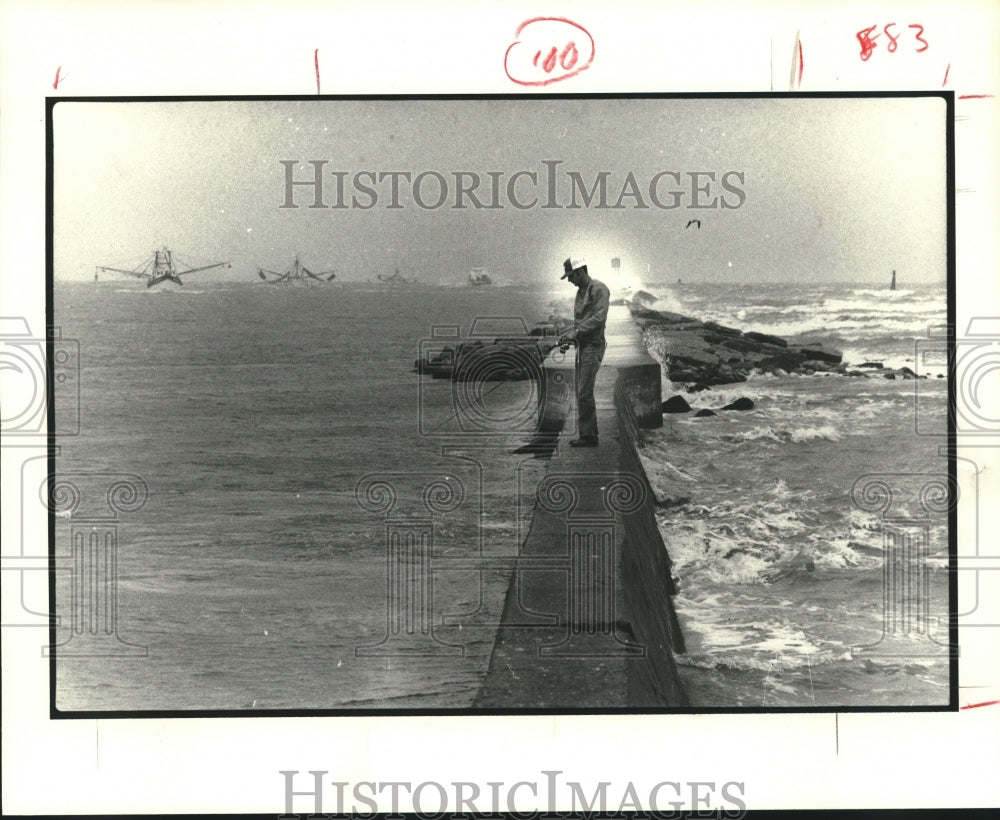 1980 Bill Fair fishes the Quintana Island, TX. breakwater - Historic Images