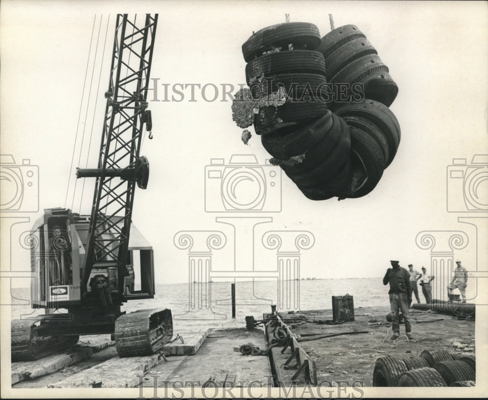 1971 Crane on barged lifts clusters in creating artificial reefs - Historic Images