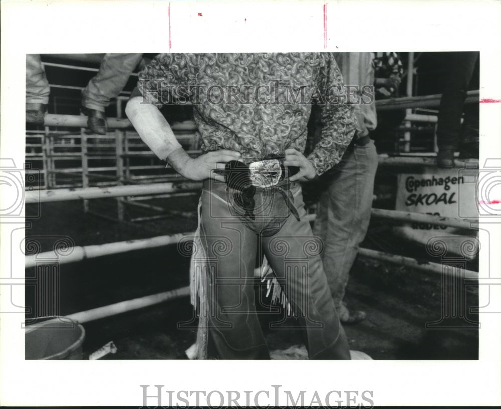 1992 Fancy belt buckle worn by Shane Davis in a Texas rodeo arena. - Historic Images