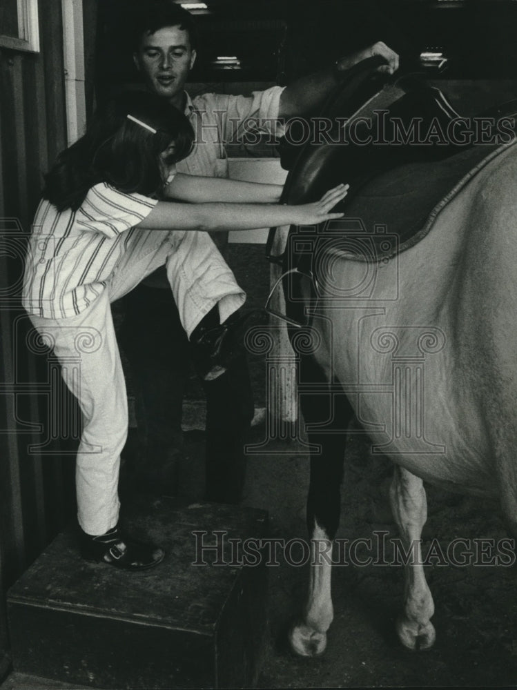 1969 Carroll Robertson Instructs Jill Wasilchak at Edgepark Stables. - Historic Images