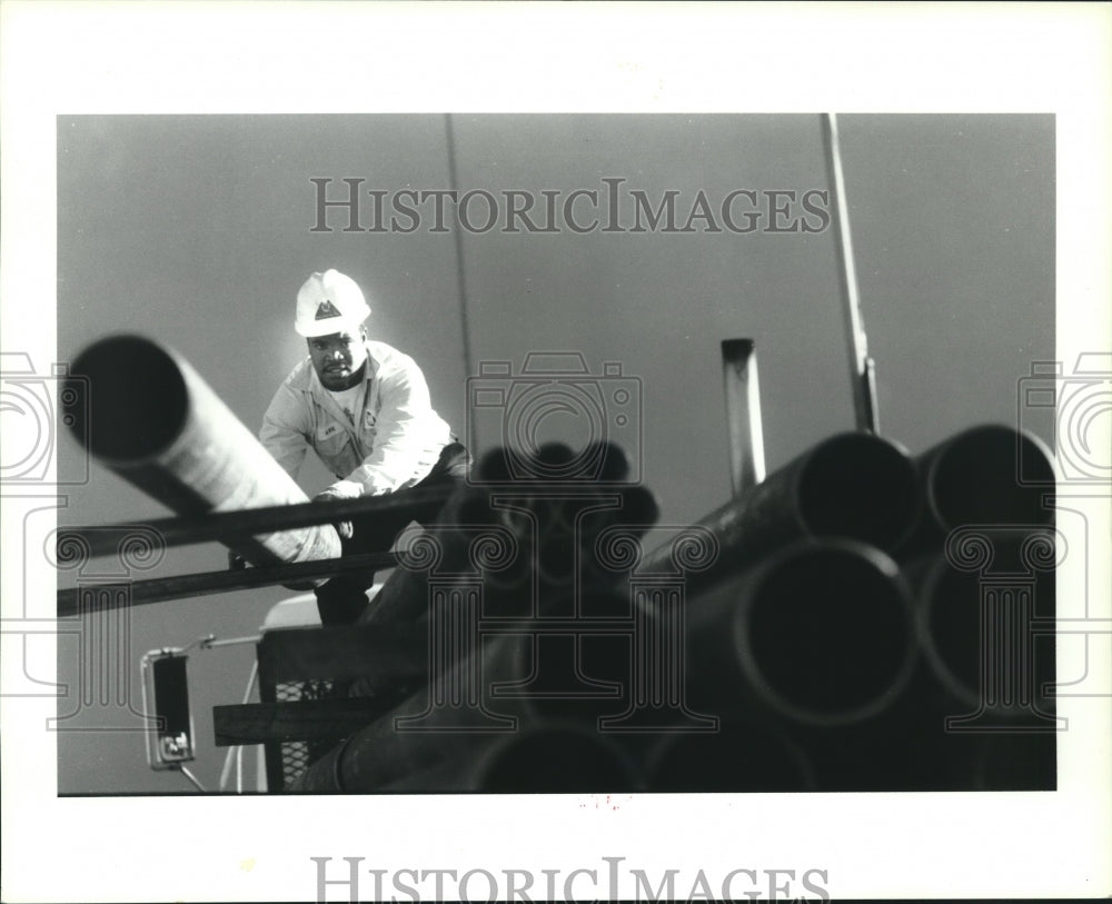 1990 Pipe Yard Worker Avie Skyler Loads Pipe, Wallace Company - Historic Images