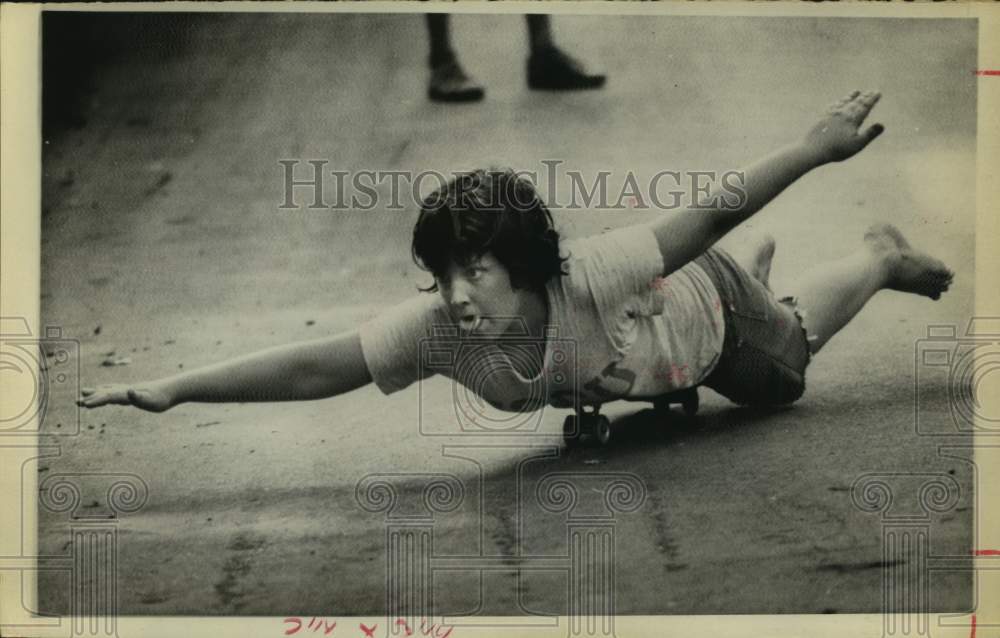 1975 Press Photo Boy does a belly buster trick on his skateboard - hcx19623- Historic Images