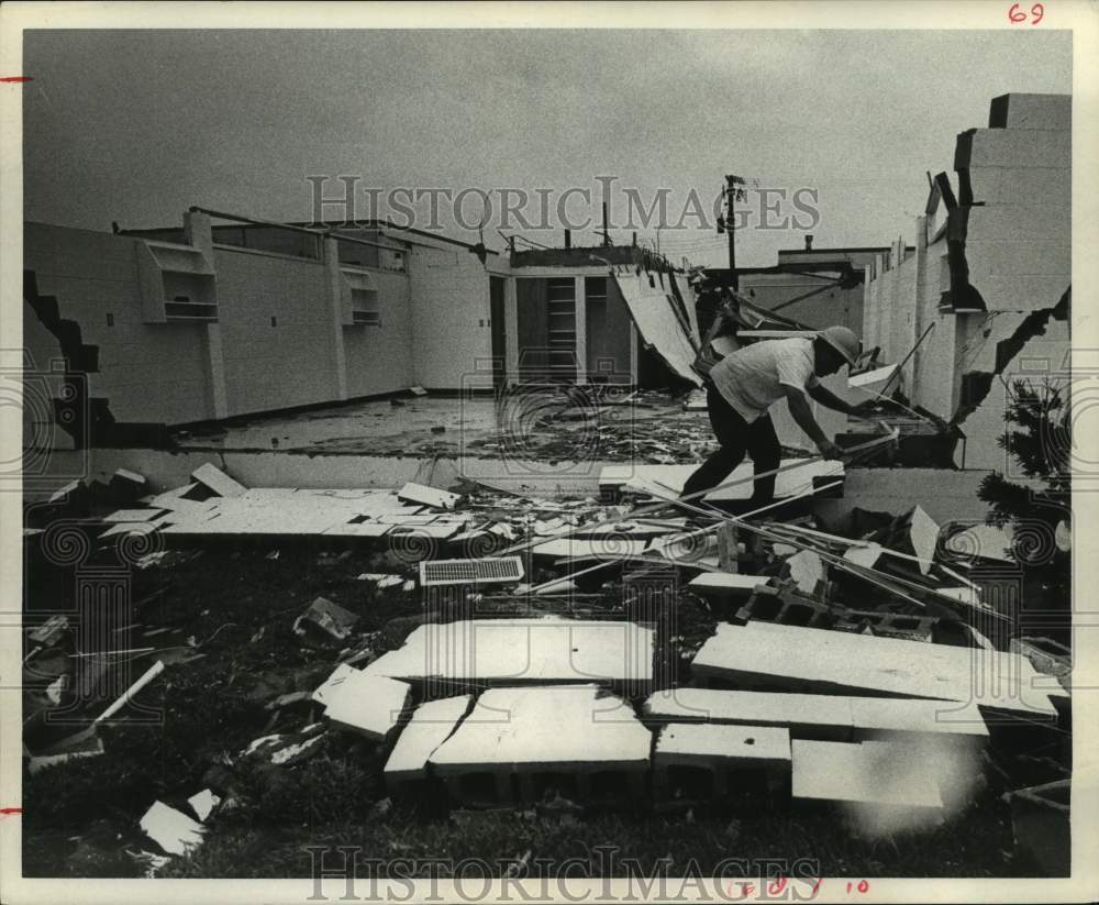 1967 Joe Ortega cleans tornado damaged building in Port Lavaca - Historic Images