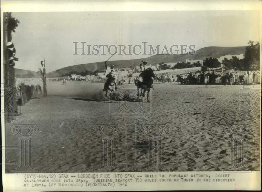 1942 People Watch as Two Cavalrymen Ride into Sfax, Tunisia - Historic Images