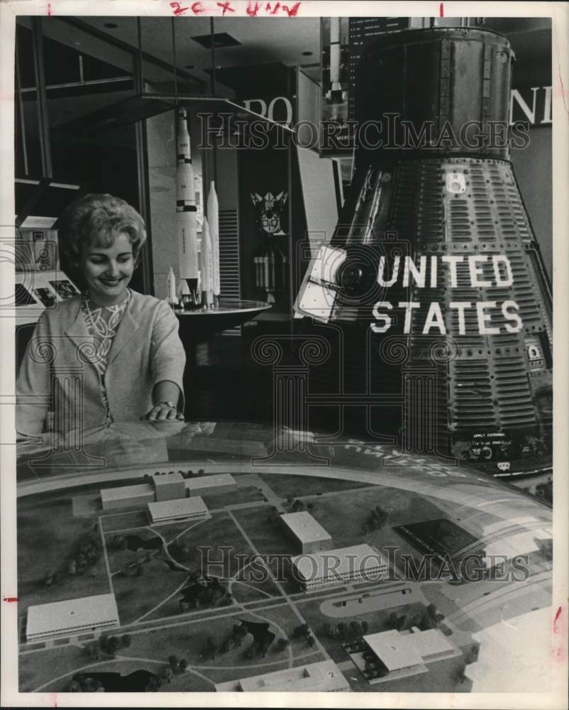 1963 Gisela Leggett examines space exhibit in World Trace Center, TX - Historic Images